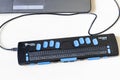 Top view of refreshable braille display and laptop