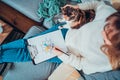 Top view relaxed young woman drawing work-life balance wheel sitting on the sofa with cat pet at home. Self-reflection Royalty Free Stock Photo