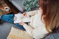 Top view relaxed young woman drawing work-life balance wheel sitting on the sofa at home. Self-reflection and life Royalty Free Stock Photo