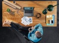 Top view of relaxing businessman working on computer at desk with coffee in home office. Royalty Free Stock Photo