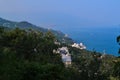 Top view of resort town with white buildings on shore of Black Sea bay among mountains, blue water, summer, green forest, trees Royalty Free Stock Photo