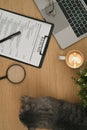 Top view of resume forms or CV and laptop computer on wooden table. Career, employment and recruitment concept