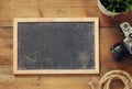 Top view and retro filtered image of blank old chalkboard, nautical rope and camera. travel and adventure concept Royalty Free Stock Photo