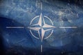 Top view of retro NATO flag with grunge textute, no flagpole. Plane design, layout. Flag background