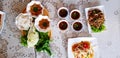 Top view of rice noodles with fresh vegetable and sweet sauce in wooden tray with spicy sauce Royalty Free Stock Photo