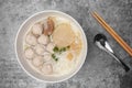 Top view rice vermicelli noodle soup with pork meatball in the white bowl on the grey concrete table Royalty Free Stock Photo