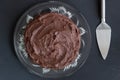 Top view of rich chocolate cake on glass plate with server on bl Royalty Free Stock Photo