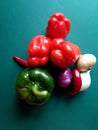 Top view of rich selection of fresh organic vegetables on a green background