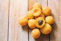 Top view of ripe apricots lying on wooden table.