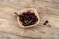 Ripe cherry in a bowl on a wooden table Royalty Free Stock Photo