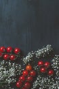 top view of ripe cherry tomatoes and white flowers on black wooden table Royalty Free Stock Photo