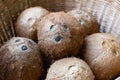 Top view of ripe coconuts in wicker basket