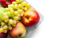 Top view of ripe fruits isolated on white background. Juicy pears, red apples and grapes are stacked in a plate. Selective soft Royalty Free Stock Photo