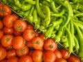 Top view of ripe juicy delicious tomatoes and fresh green peppers in a stand in grocery store. Royalty Free Stock Photo