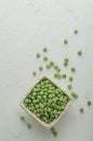 Top view Ripe pods of green peas on light concrete background. Fresh vegetables. Legumes. Flat lay