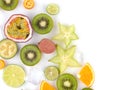 Top view of ripe and tropical slices of fruits with cubes of ice isolated on a white background. Royalty Free Stock Photo