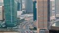 Top view of road in Dubai downtown timelapse with day traffic and business bay skyscrapers.