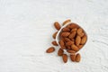 Top view of roasted almonds on white ceramic cup and space in the left side, copy space concept. Royalty Free Stock Photo