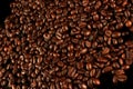 Top view of roasted coffee beans for background and texture. Piled of roasted coffee beans can be used as a background