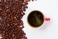 Top view roasted coffee beans and cup of coffee.