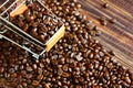 Top view roasted coffee beans on small shopping cart  on coffee beans on retro wood floor , copy space Royalty Free Stock Photo