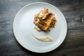 top view on roasted fish pieces served on meat salad