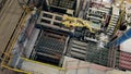 Top view of a robotized arm moving batches of bricks at amodern factory floor.