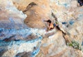 Top View of Rock Climber on orange Vertical Wall Royalty Free Stock Photo