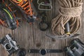 Top view of rock climbing equipment on wooden background. Chalk bag, rope, climbing shoes, belay/rappel device, carabiner and asce Royalty Free Stock Photo