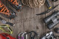 Top view of rock climbing equipment on wooden background. Chalk bag, rope, climbing shoes, belay/rappel device, carabiner and asce Royalty Free Stock Photo