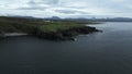 Top view of rocky coast on background of mountains on cloudy day. Clip. Beautiful northern landscape with rocky shore on Royalty Free Stock Photo