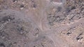 Top view of rocky stone terrain. Clip. Texture of stone lifeless land high in mountains. Grey area with no vegetation