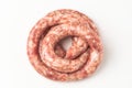 Top view on a rolled beef sausage on white background