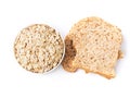 Top view of rolled oat flakes whole grain in bowl and whole wheat bread isolated on white background Royalty Free Stock Photo