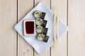 Top view of rolls with salmon, avocado and cucumber on plate with soy sauce and hashi Royalty Free Stock Photo