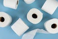 Top view of rolls of toilet paper on blue background