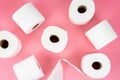 Top view of rolls of toilet paper on pink background
