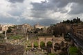 Top view of the Roman Forum against a dramatic sky. Ancient architecture and the urban landscape of historical Rome Royalty Free Stock Photo