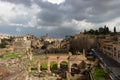 Top view of the Roman forum, illuminated by the sun, against a dramatic sky. Ancient architecture and the urban landscape Royalty Free Stock Photo