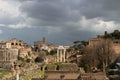 Top view of the Roman forum, illuminated by the sun, against a dramatic sky. Ancient architecture and the urban landscape of Royalty Free Stock Photo