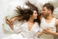 Top View of an romantic, attractive, contented, young, sexy loving couple in bed, copy space