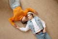 Top view of romantic loving lesbian woman couple lying face to face on floor