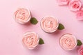 Top view of romantic Valentine cupcakes with pink buttercream shaped like a rose flowers