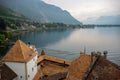 Top view of roof of chateau de chillon the medieval castle in Montreux, Switzerland, on mountain, lake and cloudy sky background Royalty Free Stock Photo