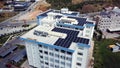 Top view of roof of white building with solar panels. Clip. Modern equipping of buildings with eco-friendly electricity