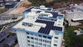 Top view of roof of white building with solar panels. Clip. Modern equipping of buildings with eco-friendly electricity