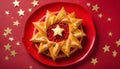 Top view of Roscon de reyes on a red plate with golden stars. Kings day concept spanish three kings cake