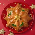 Top view of Roscon de reyes on a red plate with golden stars. Kings day concept spanish three kings cake