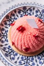 Top view of Rose and Lychee Mousses Cake decorated with rose petals in blue and white porcelain plate on marble background Royalty Free Stock Photo