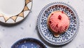 Top view of Rose and Lychee Mousses Cake decorated with rose petals in blue and white porcelain plate on marble background Royalty Free Stock Photo